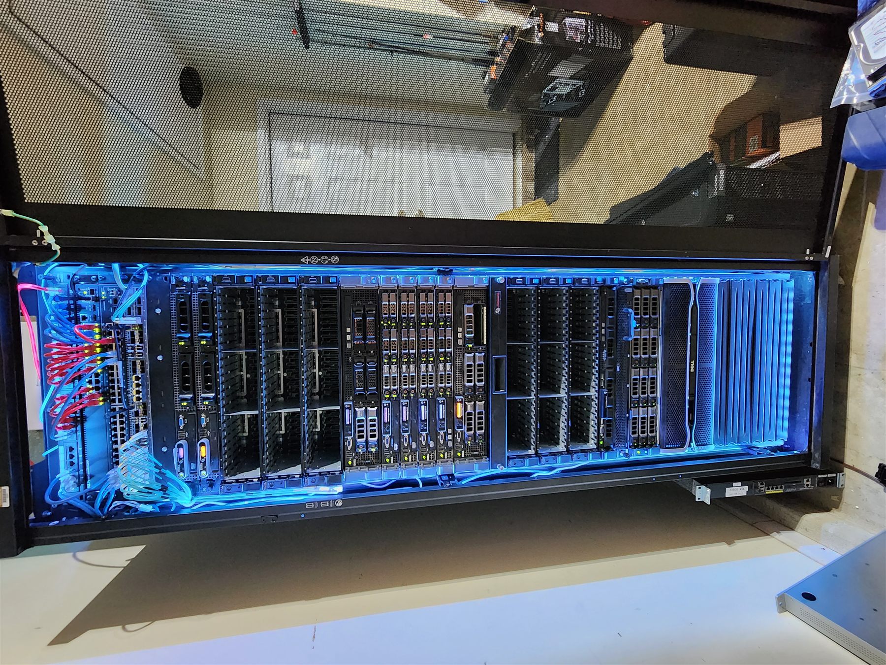 Spencer Callicott's TuxHPC homelab rack with blue LED lighting