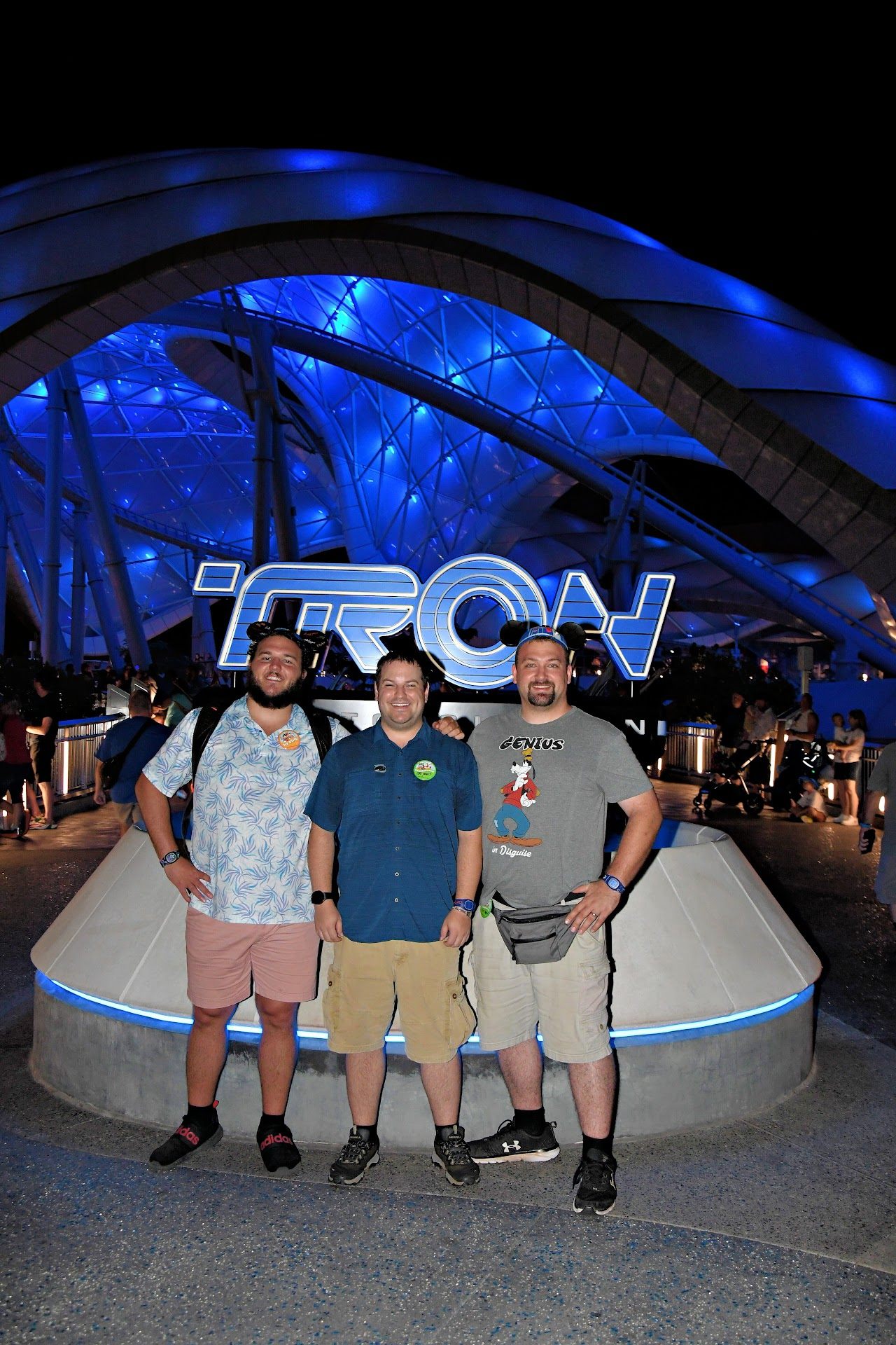 Spencer Callicott and friends under the illuminated TRON Lightcycle Run at Disney